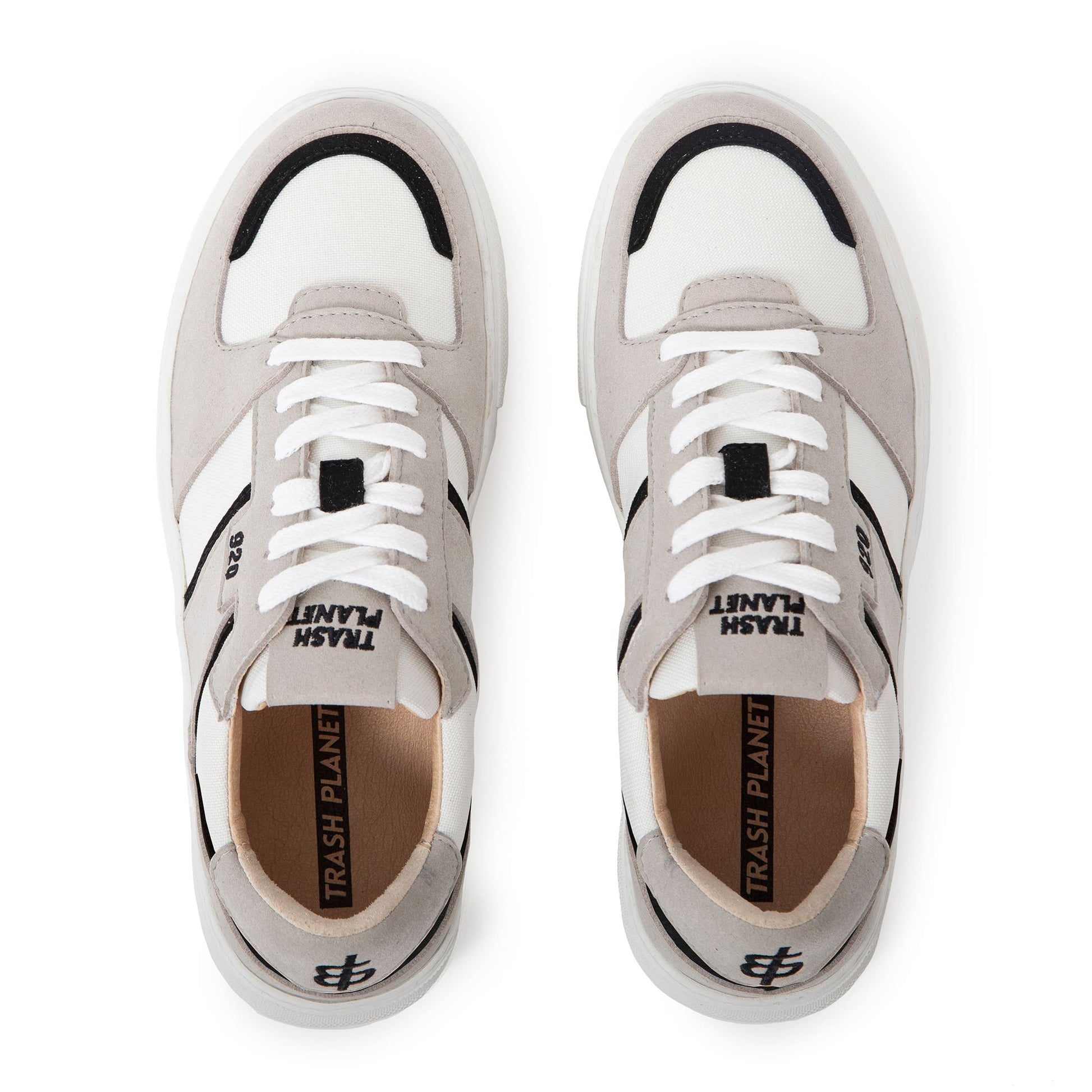 Birds eye view of a pair of black white and grey premium vegan sneakers by Trash Planet, which are made from recycled trash, plants, and fruit waste