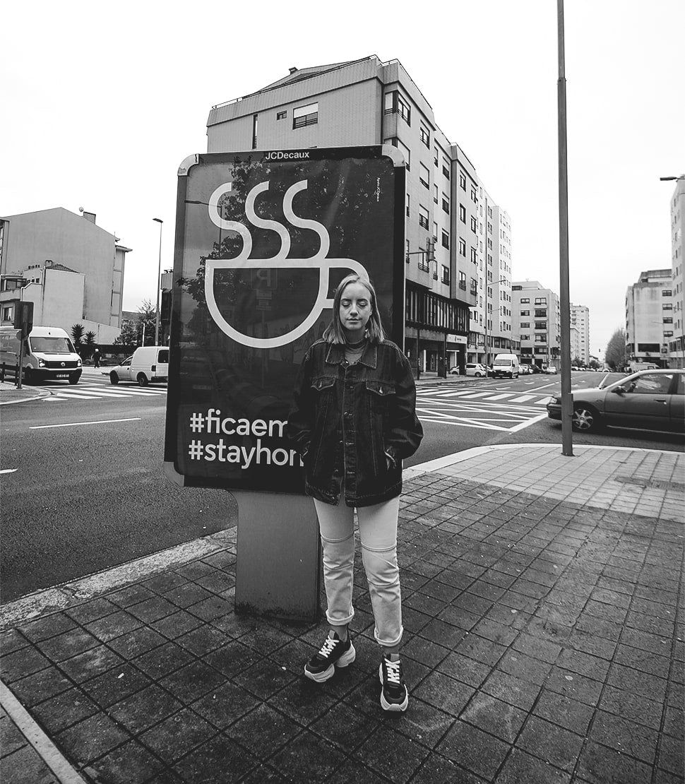 #stayhome - Trash Planet's founder Holly standing in front of a lockdown poster in Portugal during COVID-19