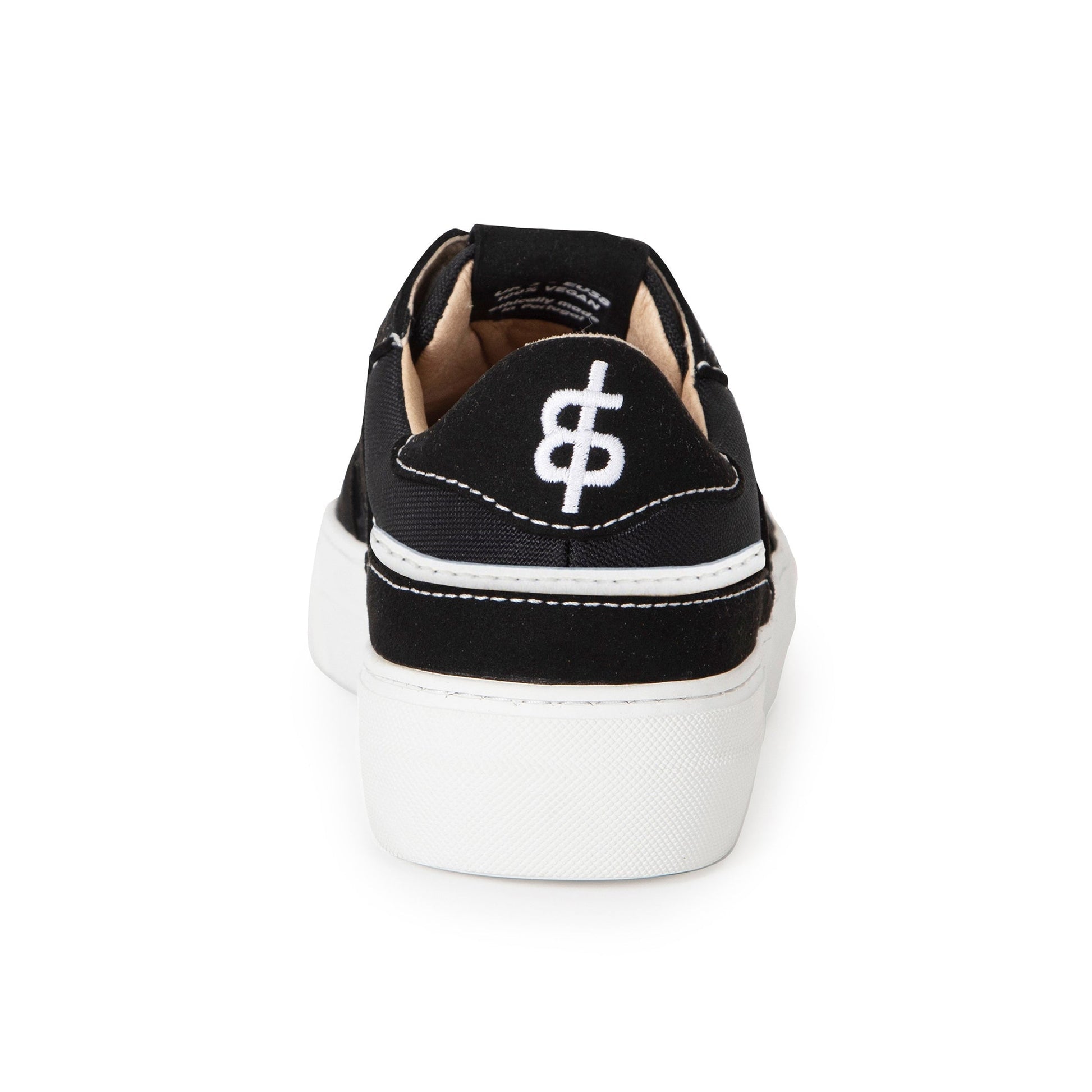 Back view of a single black and white skater style premium vegan sneakers made from fruit leathers and ocean plastic with the Trash Planet logo embroidered on the back