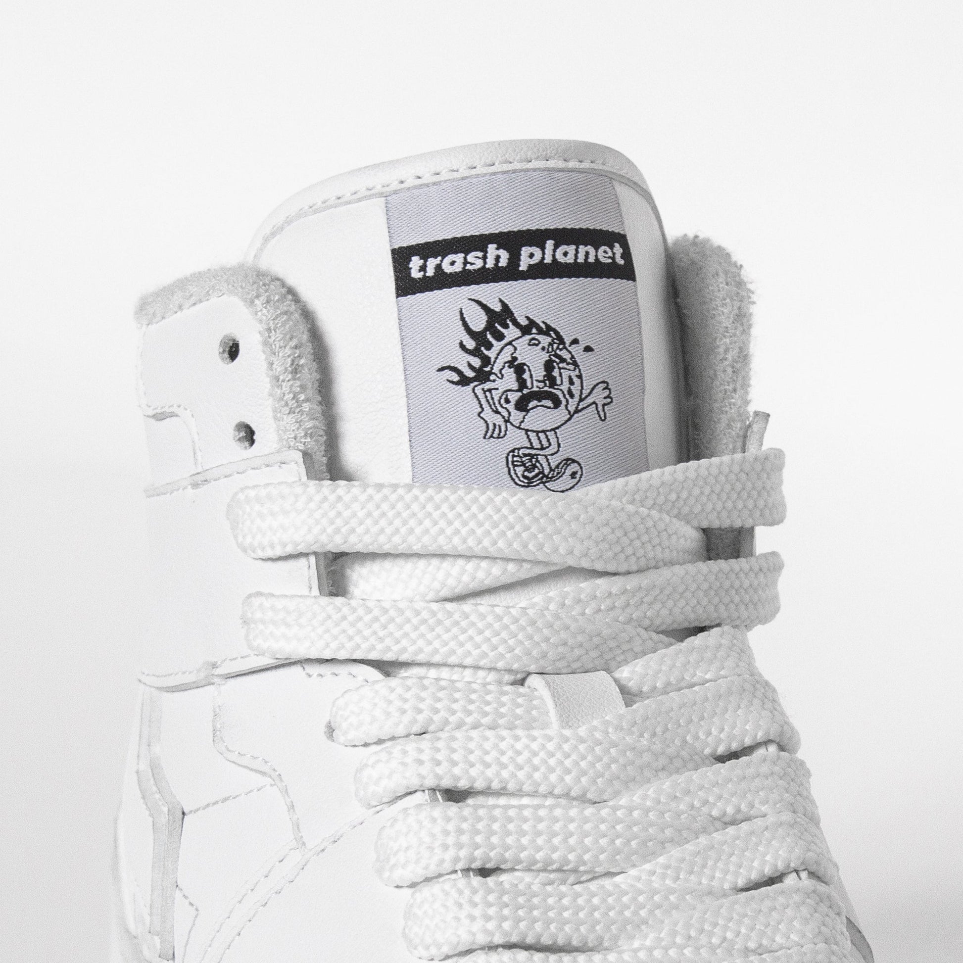 Earth on fire tongue detail on a white high top sneaker by Trash Planet 